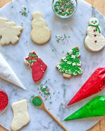 Snowman, Stocking, and Christmas Tree Cookies with icing and sprinkles for a Christmas Cookie Decorating Kit.