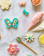 Flower, butterfly, mini flower, and mini butterfly cookies, with royal icing and sugar sprinkles to create a Cookie Decorating Kit for Spring.
