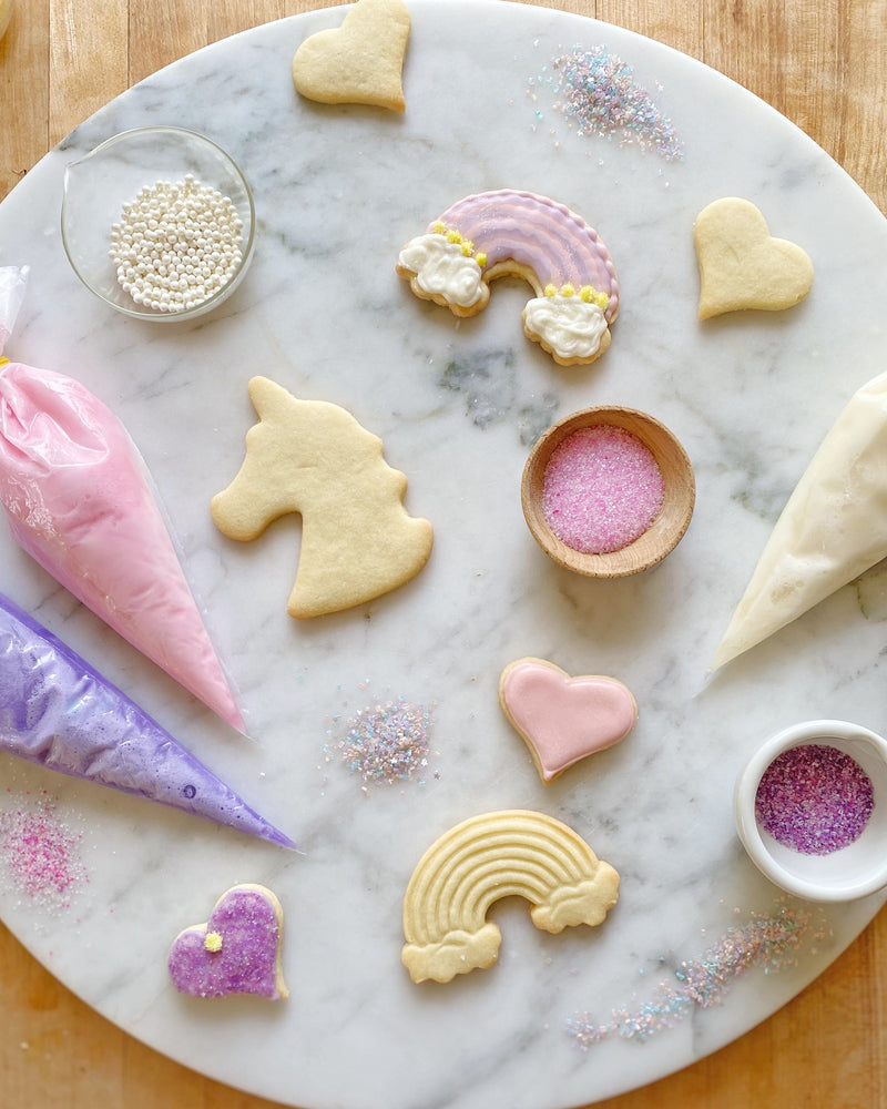 Unicorn, Rainbow, and Heart cookies, with royal icing and sugar sprinkles in the Unicorn Cookie Decorating Kit. It's all rainbows and unicorns while making memories together.